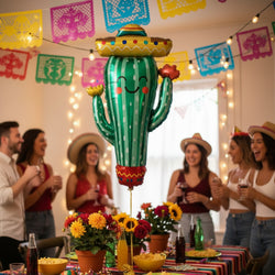 A metallic foil cactus balloon with a smiling face, wearing a yellow sombrero and red accents, isolated on a white background.