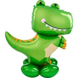 Inflatable foil balloon in the shape of a green T-Rex dinosaur with a smiling face and orange details on its back and tail.