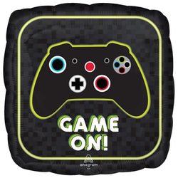A jumbo foil balloon with a gaming theme, featuring a black background with a joystick and game buttons in green and red, and the text 'Game On!' in bold green letters.