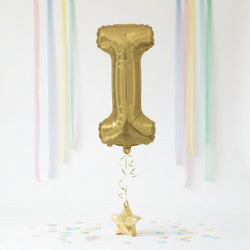 Gold number '1' balloon with decorative ribbons and confetti on a white background