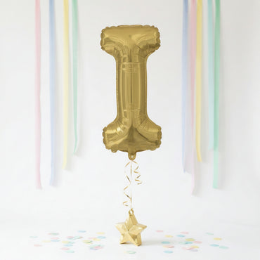 Gold number '1' balloon with decorative ribbons and confetti on a white background