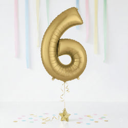 Gold number 6 balloon with a star-shaped balloon on a white background with colorful streamers.