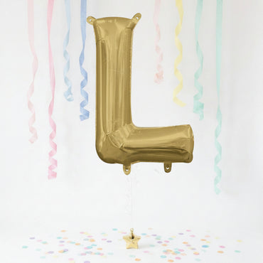 Gold letter 'L' balloon with pastel streamers and confetti on a white background