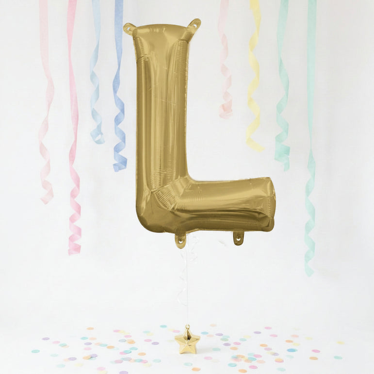 Gold letter 'L' balloon with pastel streamers and confetti on a white background