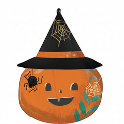 A round, satin balloon with a pumpkin design, featuring a witch's hat with spiders and webs, and a smiling face with leaves around it.
