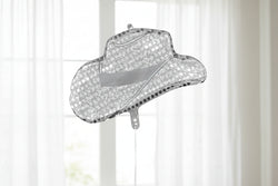 Sparkly cowboy hat ornament on a white background