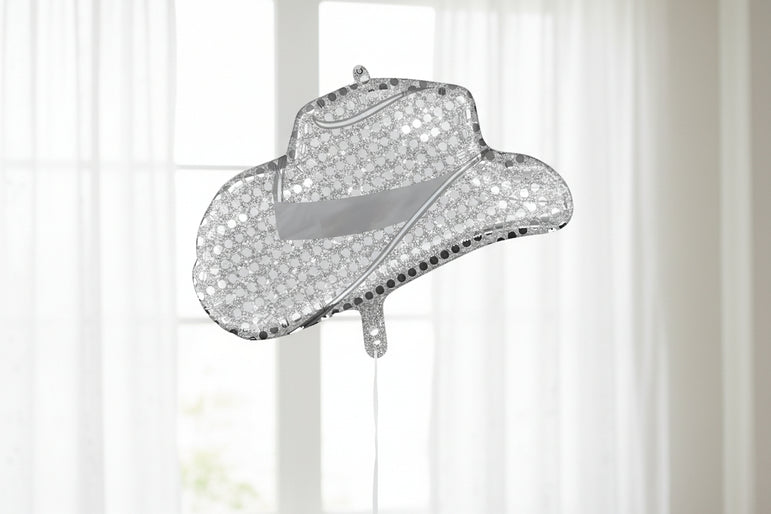 Sparkly cowboy hat ornament on a white background
