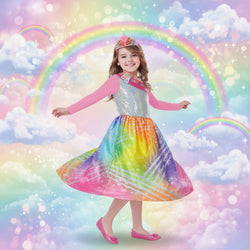 Child wearing a colorful dress with a rainbow pattern on a white background