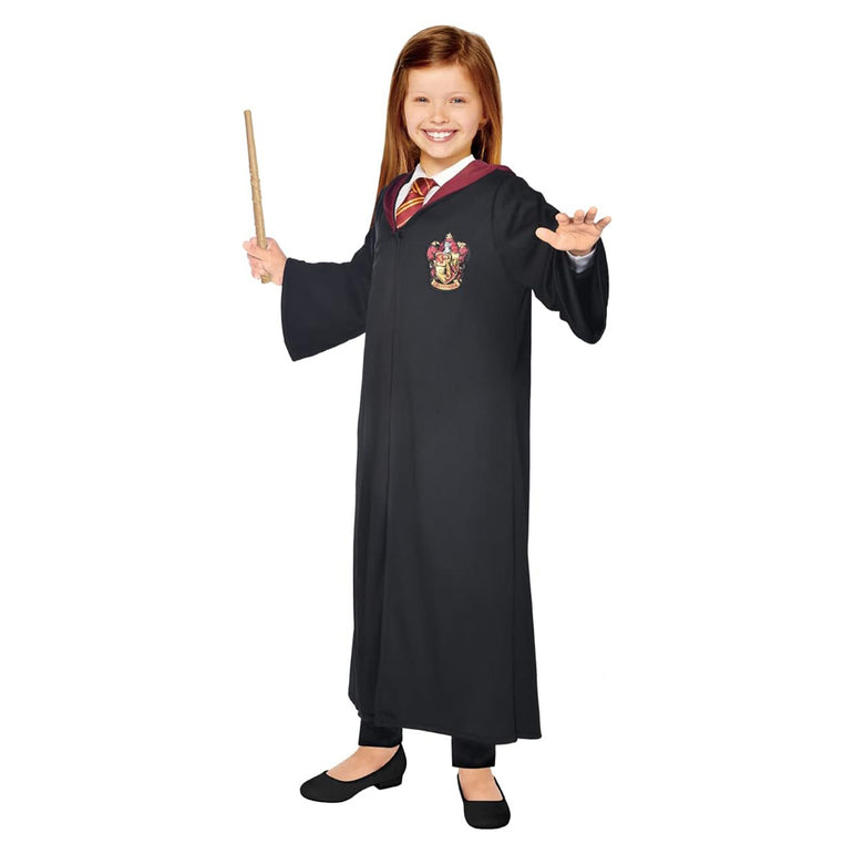 Child dressed in a Hermione Granger costume from the Harry Potter series, featuring a black robe with the Gryffindor crest, a scarf, and holding a wand.