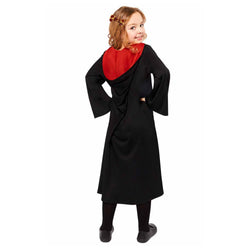 Child in black robe costume with red hood, smiling and looking over shoulder.