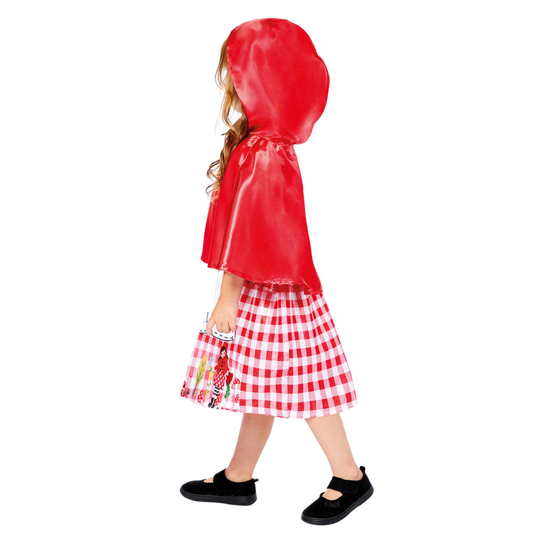 Side view of child wearing Little Red Riding Hood costume with red cape and gingham skirt.